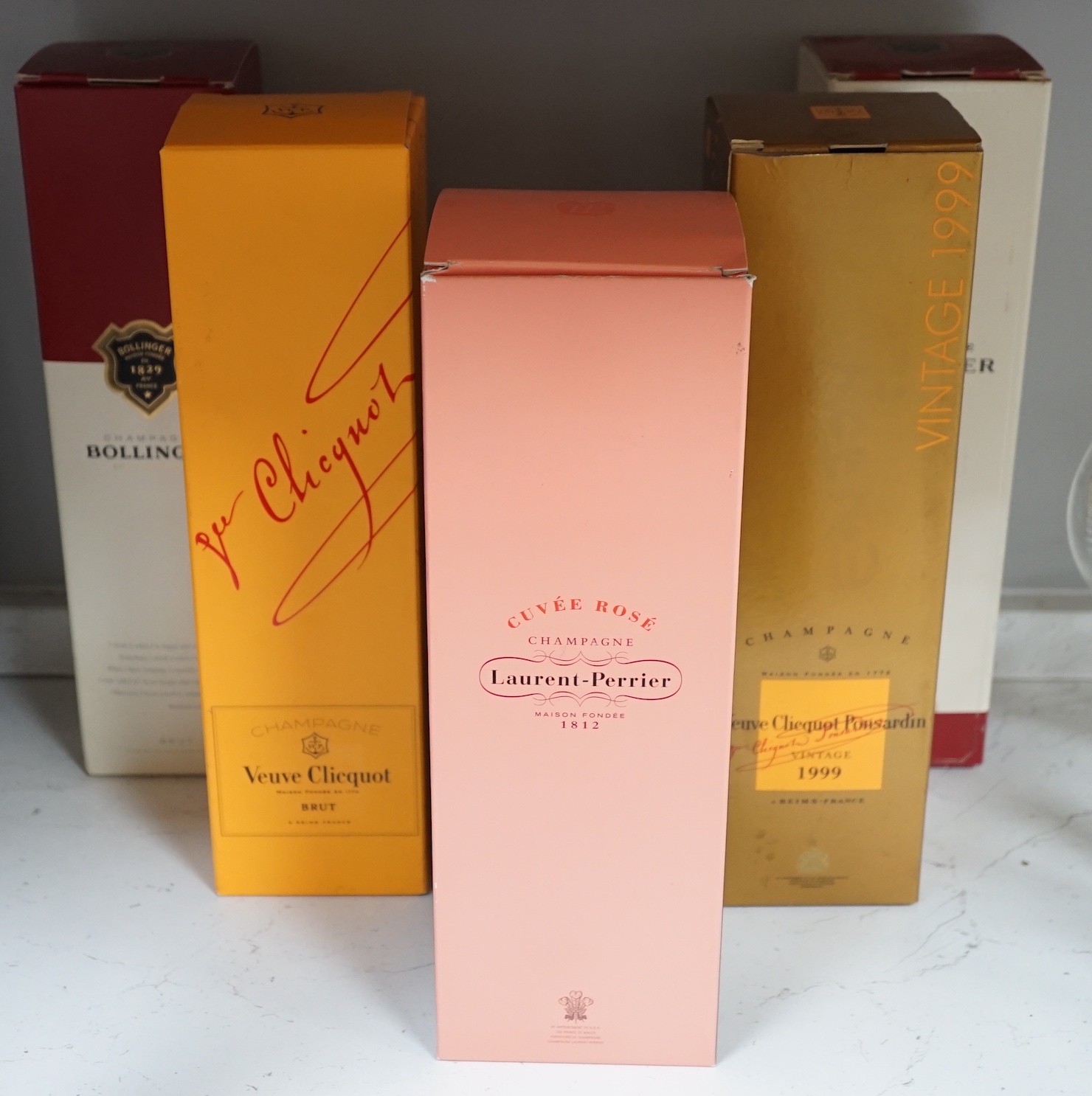 A boxed bottle of Veuve Clicquot 1999 vintage Champagne, a similar boxed NV Champagne, two boxed Bollinge Special Cuvee NV Champagne and a boxed Laurent Perrier NV Champagne.